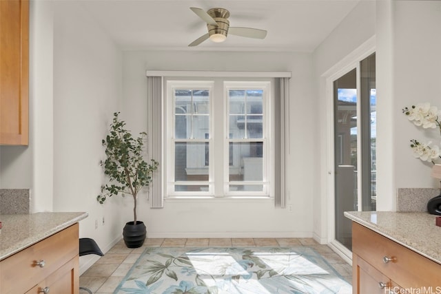 dining area featuring light tile patterned floors, baseboards, and a ceiling fan