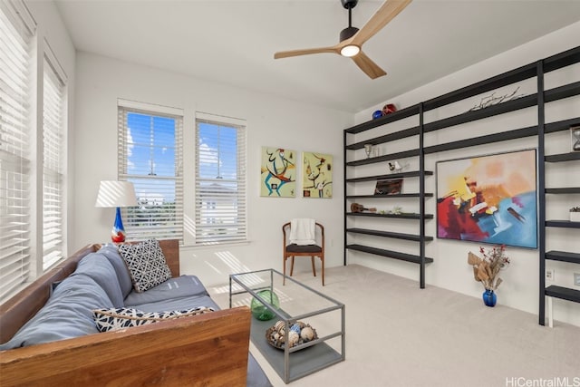 carpeted living area featuring ceiling fan