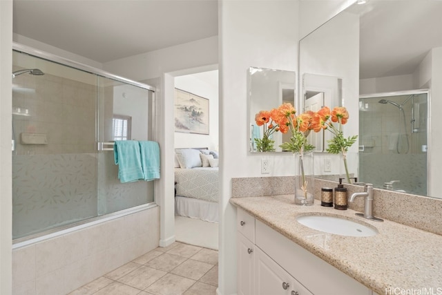 bathroom with a shower stall, tile patterned floors, ensuite bath, and vanity
