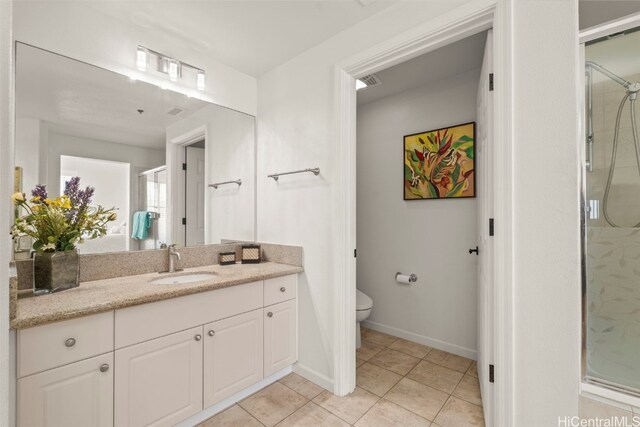 bathroom with vanity, baseboards, tile patterned floors, toilet, and a shower stall