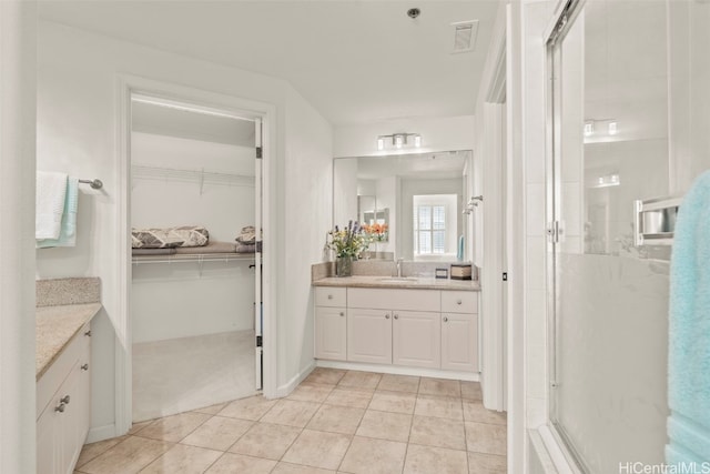 bathroom featuring visible vents, a shower stall, and vanity