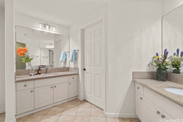full bathroom with a sink, tile patterned floors, and two vanities
