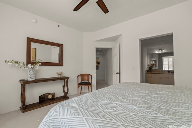 bedroom with light carpet, ceiling fan, and ensuite bath