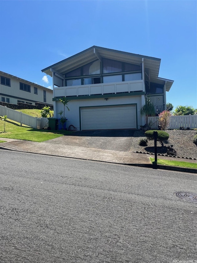 view of front of house featuring driveway and fence