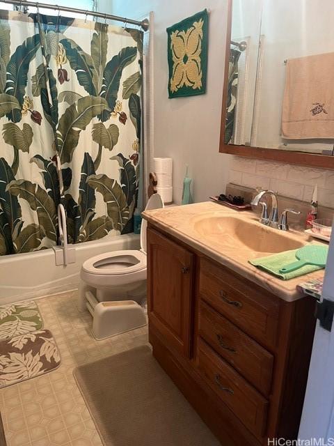 bathroom featuring toilet, shower / bathtub combination with curtain, vanity, backsplash, and tile patterned floors