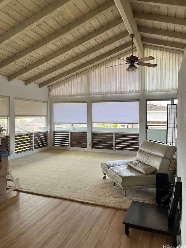sunroom / solarium featuring beam ceiling and ceiling fan