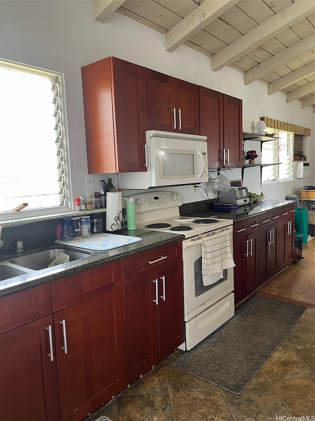 kitchen with white appliances, reddish brown cabinets, and beam ceiling