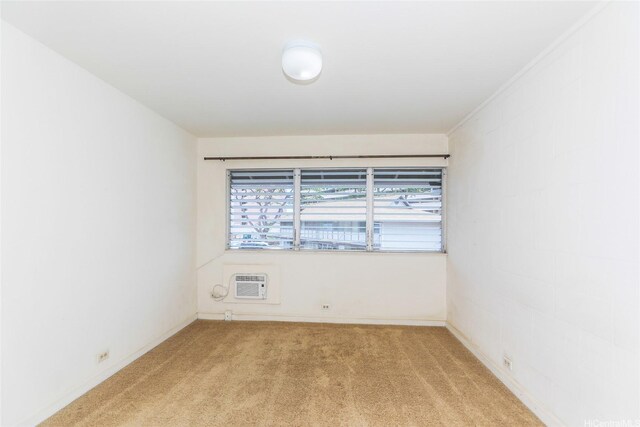 4202 Keanu St Unit 4, Honolulu, HI 96816 - empty room with light colored carpet, a wall mounted air conditioner, and baseboards