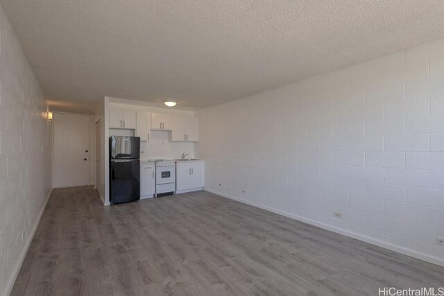 5122 Likini St Unit 616, Honolulu, HI 96818 - kitchen featuring freestanding refrigerator, white stove, dark wood-style floors, white cabinetry, and light countertops