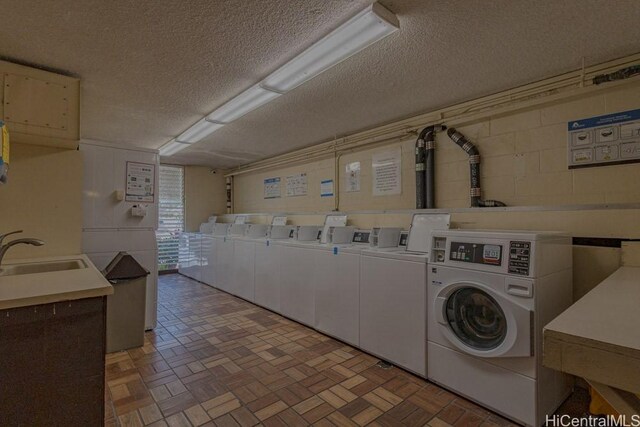 5122 Likini St Unit 616, Honolulu, HI 96818 - shared laundry with independent washer and dryer and a textured ceiling