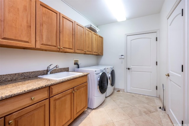 washroom featuring washer and clothes dryer, a sink, light tile patterned floors, and cabinet space