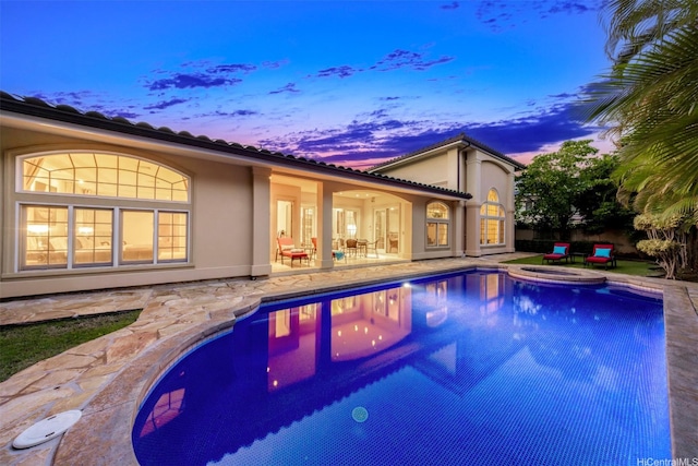 view of pool featuring a patio and a pool with connected hot tub