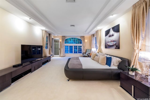 living area with carpet, visible vents, and a tray ceiling