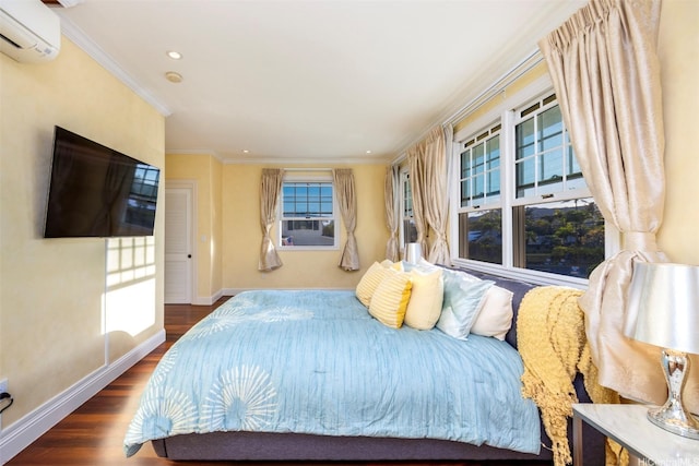 bedroom with ornamental molding, recessed lighting, wood finished floors, a wall mounted air conditioner, and baseboards