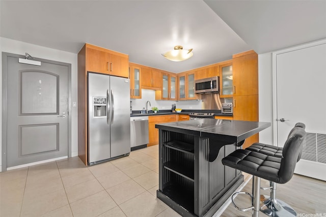 1009 Kapiolani Blvd Unit 4006, Honolulu, HI 96814 - kitchen with stainless steel appliances, dark countertops, glass insert cabinets, a breakfast bar area, and open shelves
