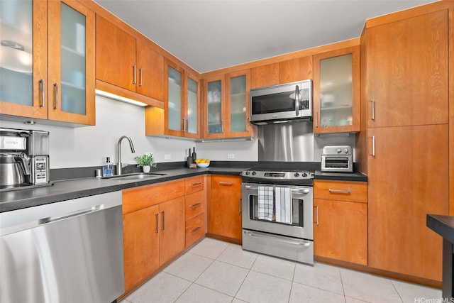 1009 Kapiolani Blvd Unit 4006, Honolulu, HI 96814 - kitchen featuring stainless steel appliances, glass insert cabinets, light tile patterned flooring, dark countertops, and brown cabinetry