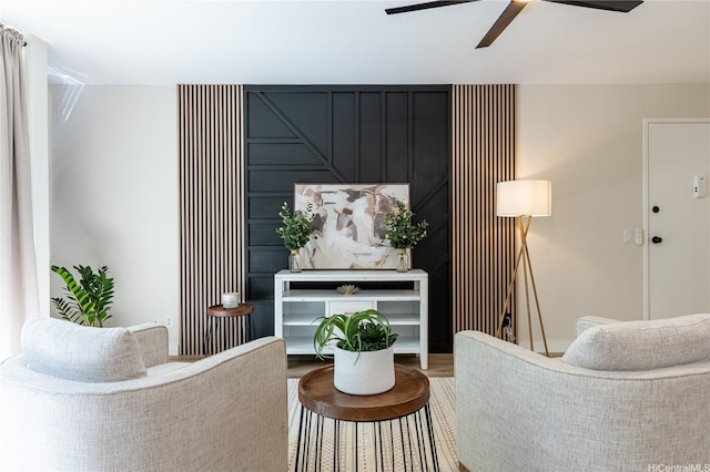 living area featuring ceiling fan and wood finished floors