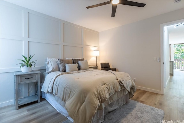bedroom featuring light wood-style floors, baseboards, and ceiling fan