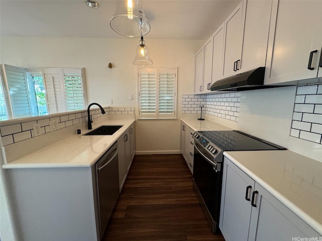 kitchen featuring a sink, dark wood finished floors, backsplash, electric range oven, and dishwasher