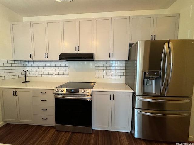 kitchen with under cabinet range hood, appliances with stainless steel finishes, dark wood-style floors, and light countertops