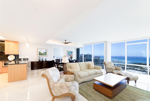 living room with a water view and light tile patterned floors