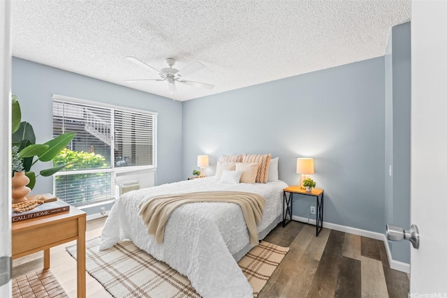 91-1060 Puamaeole St Unit 12B, Ewa Beach, HI 96706 - bedroom with wood finished floors, baseboards, ceiling fan, and a textured ceiling