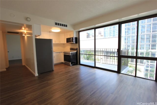 225 Queen St Unit 8C, Honolulu, HI 96813 - kitchen featuring visible vents, light countertops, white cabinetry, stainless steel appliances, and dark wood-type flooring