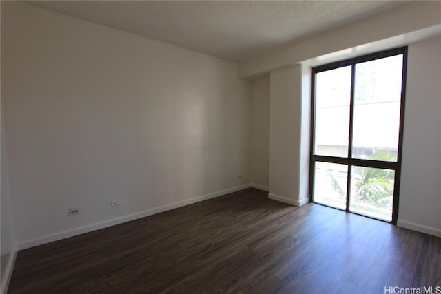 225 Queen St Unit 8C, Honolulu, HI 96813 - spare room with dark wood-style flooring and baseboards