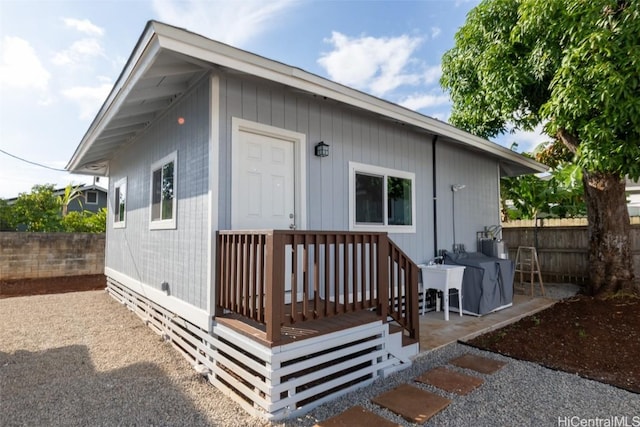 view of outbuilding featuring fence
