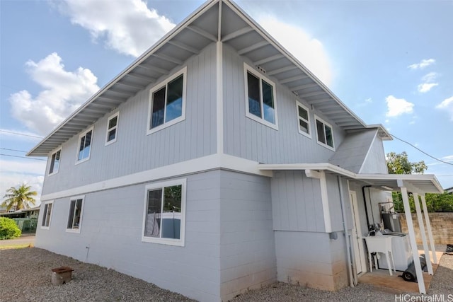 view of home's exterior with concrete block siding