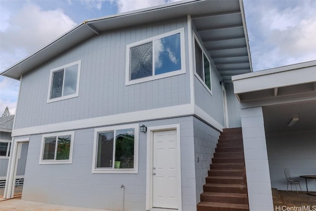 back of house with stairs