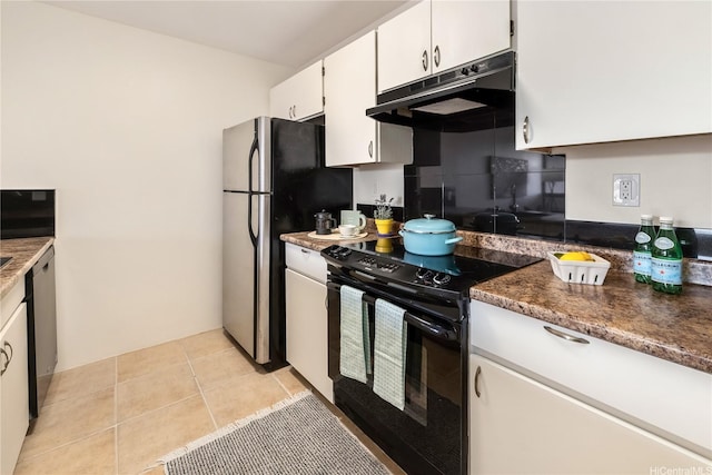 kitchen featuring stainless steel appliances, under cabinet range hood, light tile patterned floors, and white cabinets
