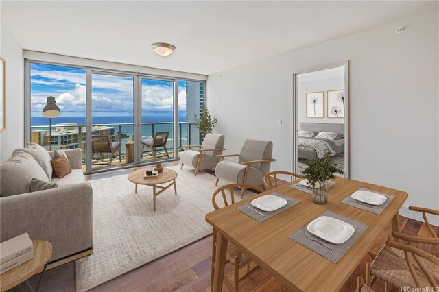 1189 Waimanu St Unit 3502, Honolulu, HI 96814 - living room featuring a water view, wood finished floors, and a wall of windows