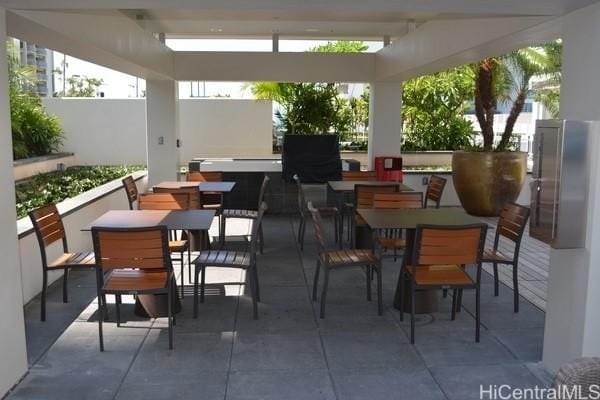 1189 Waimanu St Unit 3502, Honolulu, HI 96814 - view of patio featuring fence and outdoor dining space