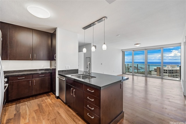 1189 Waimanu St Unit 3502, Honolulu, HI 96814 - kitchen featuring a wall of windows, dark countertops, a sink, a peninsula, and open floor plan