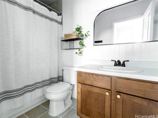 bathroom with toilet, tile patterned floors, and vanity