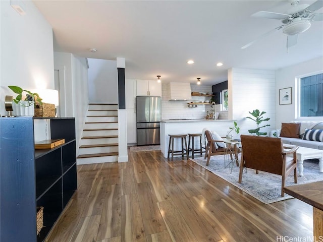 living area featuring recessed lighting, stairs, ceiling fan, and wood finished floors