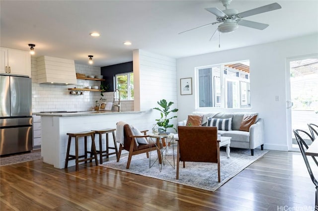 living room with ceiling fan, baseboards, dark wood finished floors, and recessed lighting