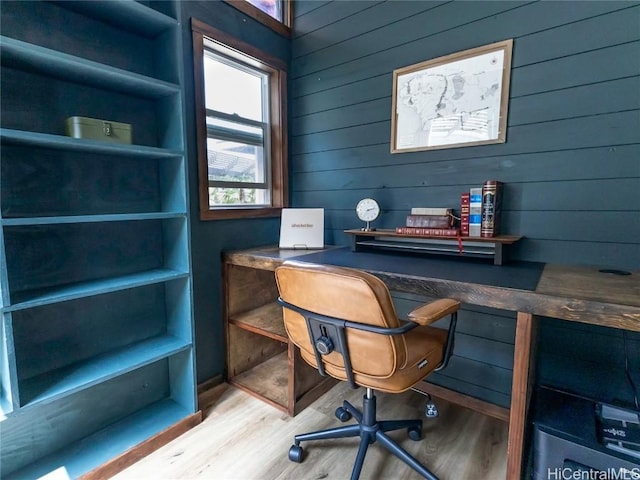 home office featuring wooden walls and wood finished floors
