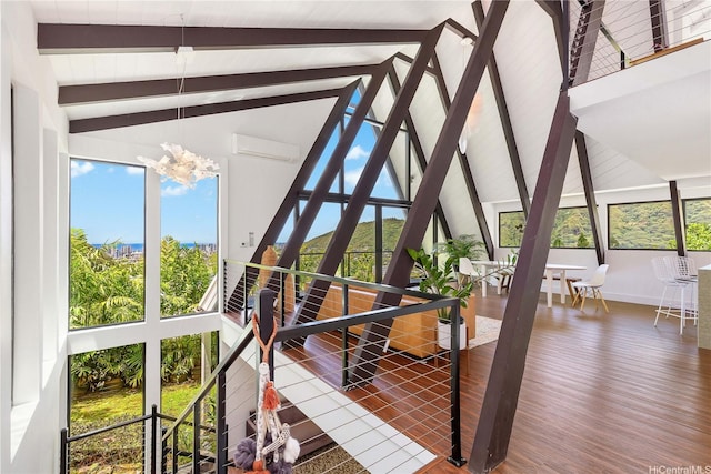 sunroom / solarium featuring a wall mounted AC, an inviting chandelier, beam ceiling, and plenty of natural light