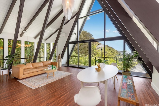 living area with high vaulted ceiling, beamed ceiling, wood finished floors, and plenty of natural light
