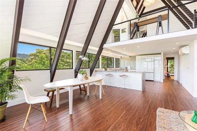sunroom featuring beamed ceiling, a sink, and a wall mounted AC