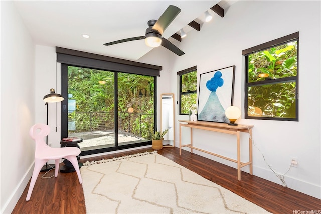 unfurnished room featuring baseboards, wood finished floors, a ceiling fan, and beamed ceiling