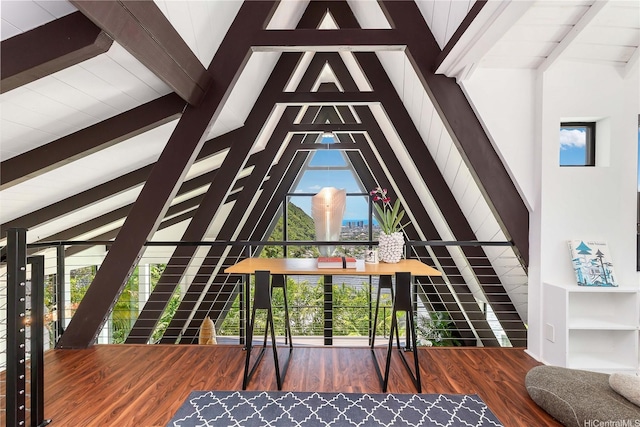 interior space with lofted ceiling with beams and wood finished floors