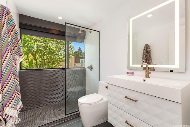 bathroom with recessed lighting, a stall shower, toilet, and vanity