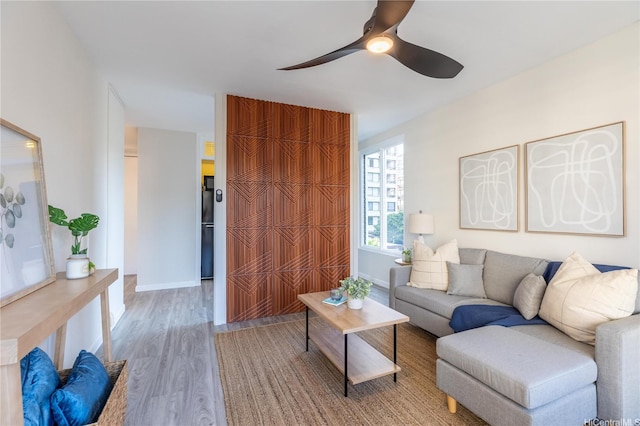 445 Kaiolu St Unit 604, Honolulu, HI 96815 - living room with wood finished floors, a ceiling fan, and baseboards