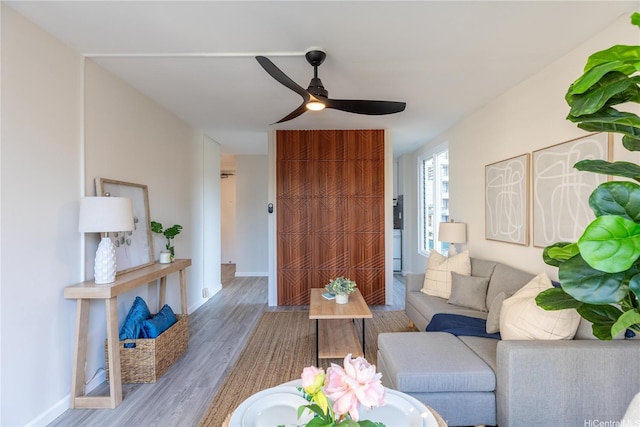 445 Kaiolu St Unit 604, Honolulu, HI 96815 - living area with a ceiling fan, wood finished floors, and baseboards