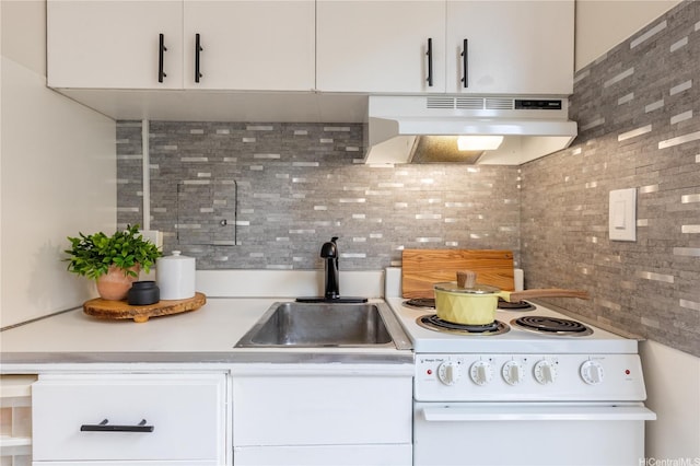 445 Kaiolu St Unit 604, Honolulu, HI 96815 - kitchen featuring under cabinet range hood, white electric stove, tasteful backsplash, a sink, and white cabinets