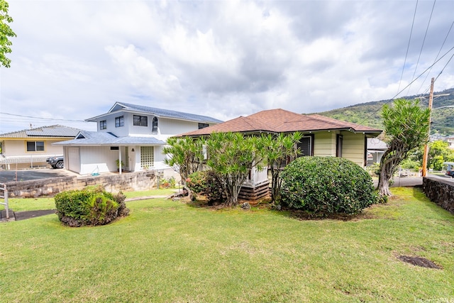 bungalow-style home with fence and a front yard