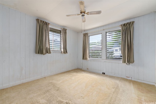 unfurnished room featuring carpet flooring, ceiling fan, and plenty of natural light